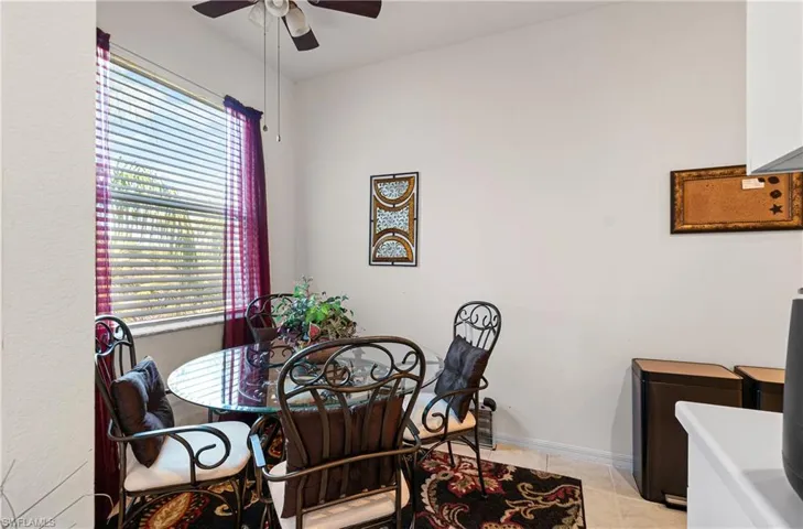 Dining area with a ceiling fan and light tile patterned floors
