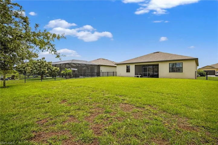 Back of property featuring a fenced backyard and stucco siding