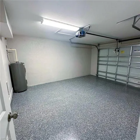 Garage with water heater and a garage door opener