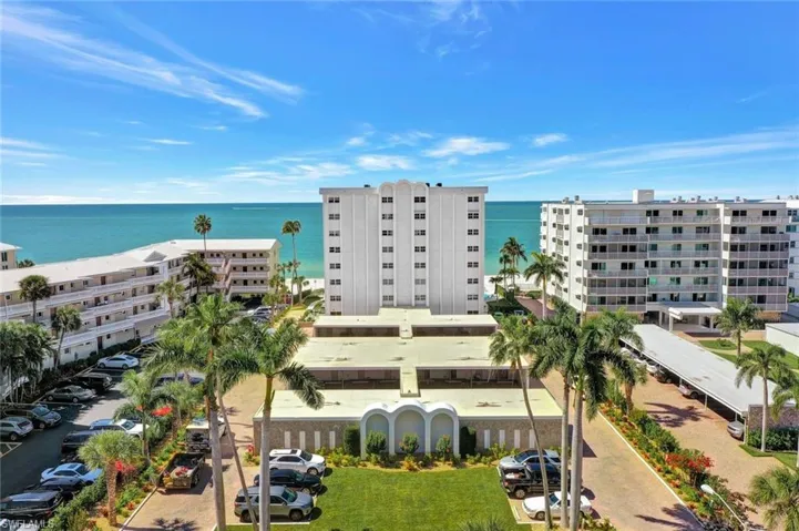 The Naples Diplomat as viewed from Gulf Shore Blvd N, with covered parking in front.