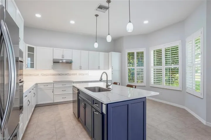 Kitchen w/ Quartz Countertops, Subway Tile Backsplash w/ Decorative Glass, Pendant Lighting