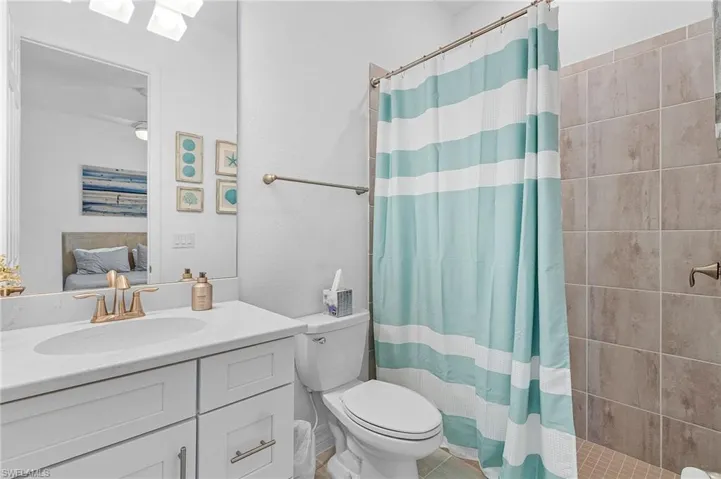 Bathroom featuring toilet, vanity, and tile patterned flooring