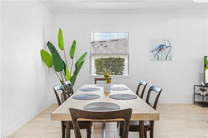 Dining room featuring a wealth of natural light and crown molding