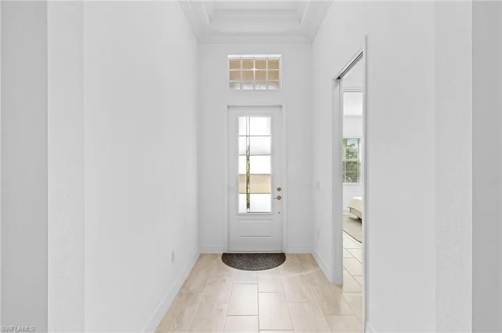 Entryway with light tile patterned floors