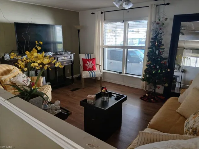 Living area featuring dark wood-style floors and healthy amount of natural light