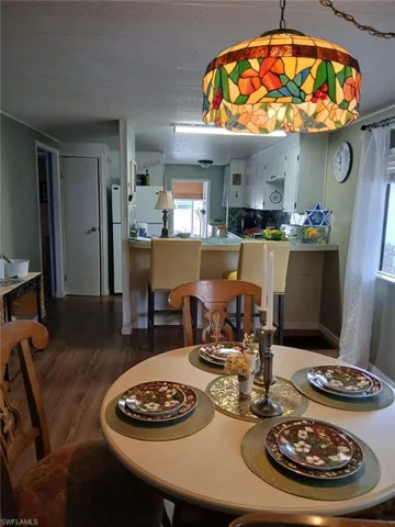 Dining space with dark wood-style floors