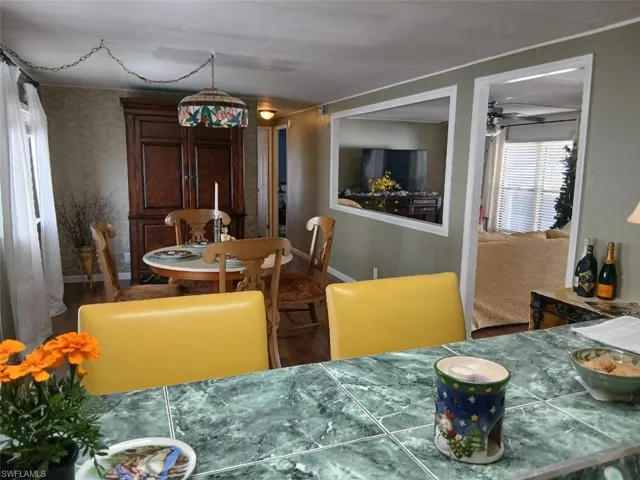Dining room featuring wood finished floors and baseboards