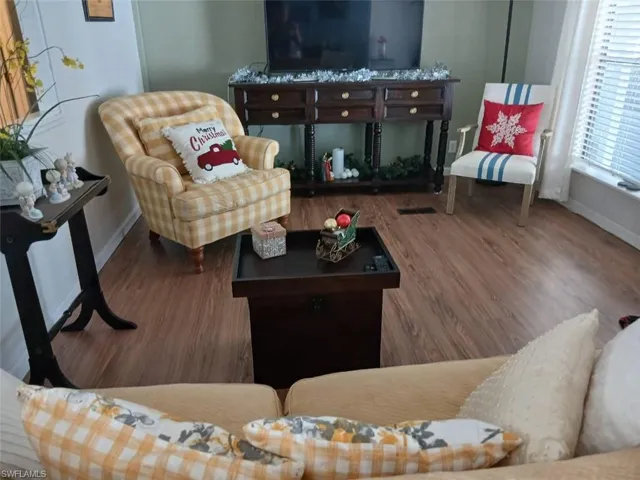 Living area with wood finished floors and baseboards