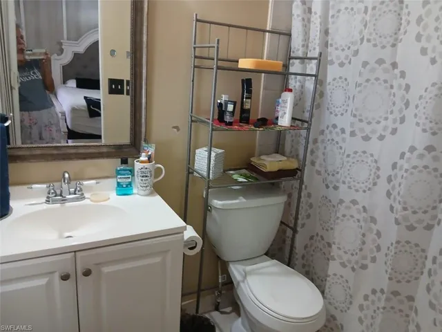 Bathroom with a shower with shower curtain and vanity