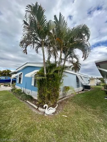 View of side of home featuring a yard