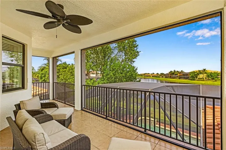 Sunroom featuring a water view and ceiling fan