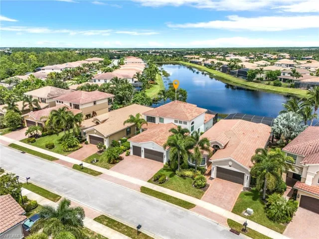 Birds eye view of property with a water view