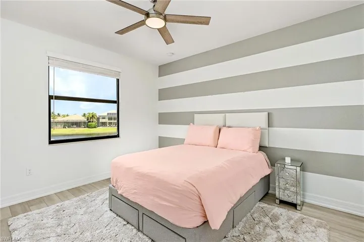 Bedroom featuring ceiling fan and light wood-type flooring