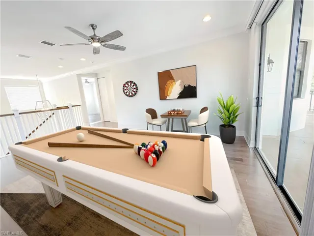 Playroom with crown molding, light wood-type flooring, billiards, and ceiling fan