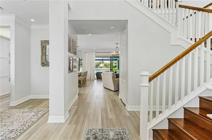 Entrance foyer featuring light hardwood / wood-style flooring and ornamental molding