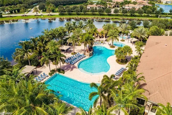 View of swimming pool with a water view and a patio