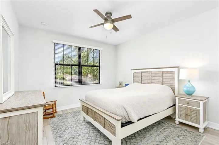 Bedroom featuring ceiling fan and light hardwood / wood-style flooring