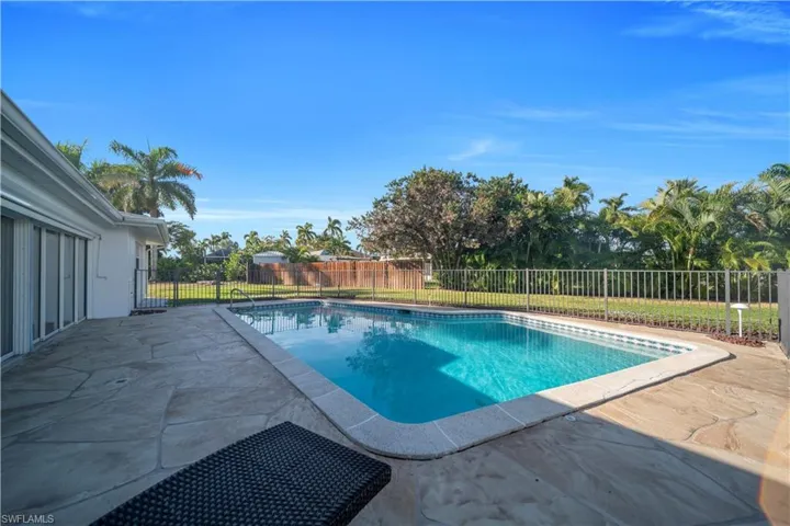 View of pool with patio surround and a fenced backyard