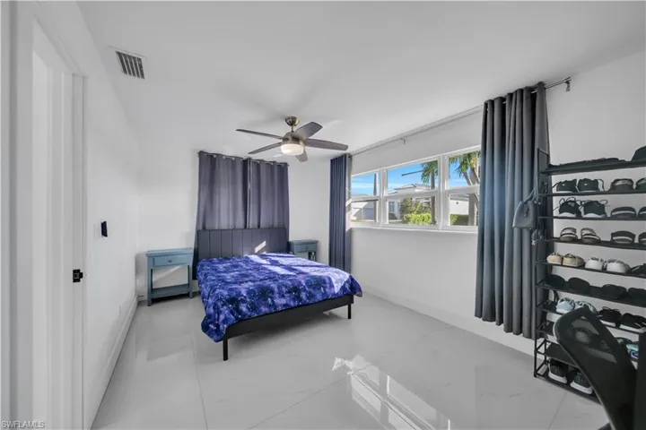Bedroom featuring baseboards and ceiling fan