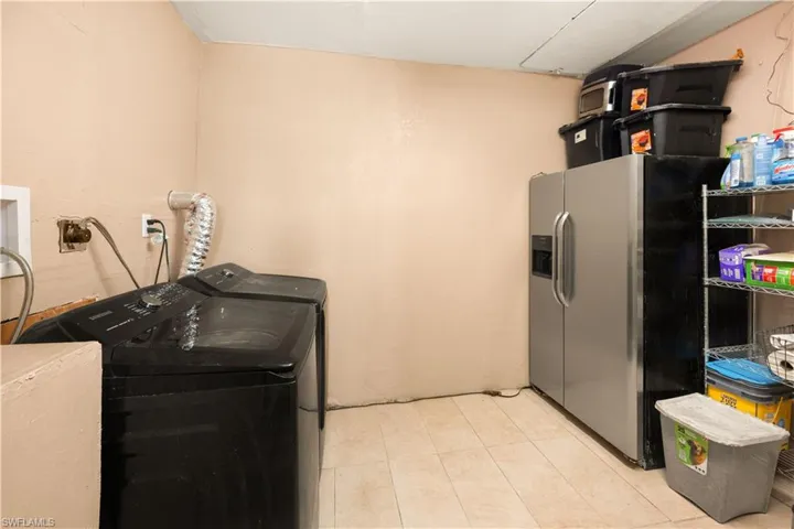 Laundry room  with washer - dryer. Extra fridge is excluded from sale