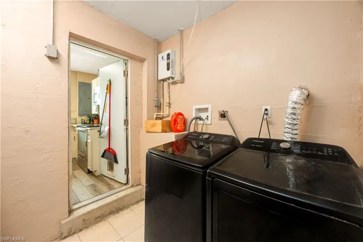Laundry area featuring washer and dryer and tile floors