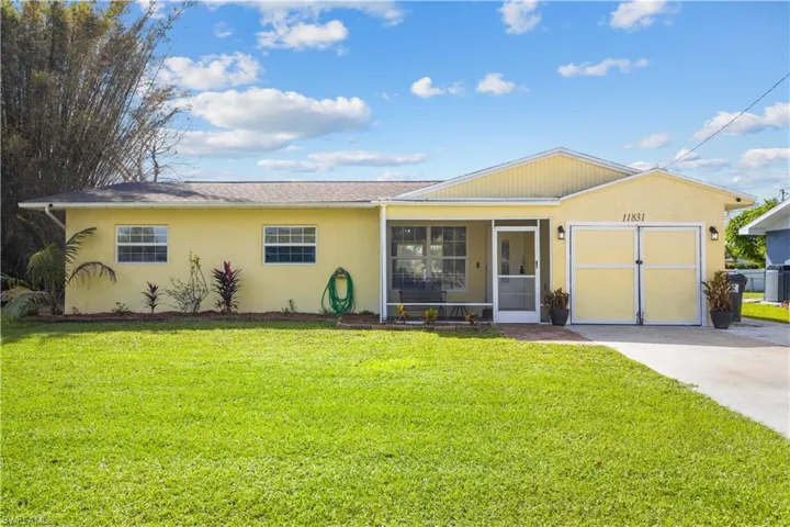 Family home featuring a front yard, a garage, and sweet screened front porch