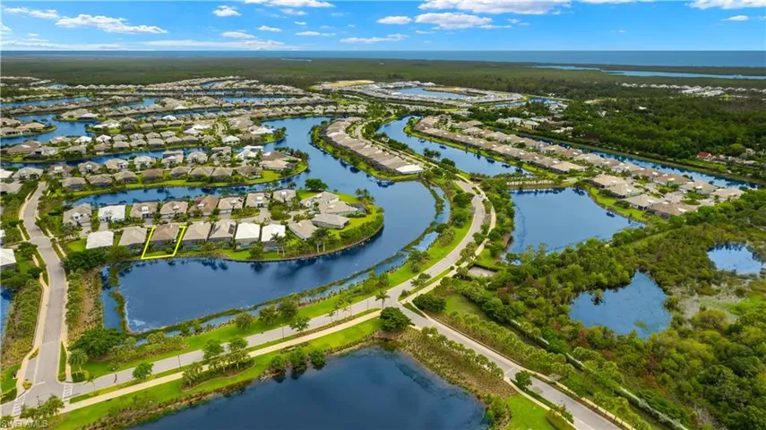 Birds eye view of property with a water view