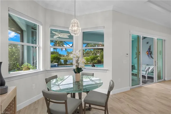 Dining space featuring light wood-type tile flooring and a chandelier