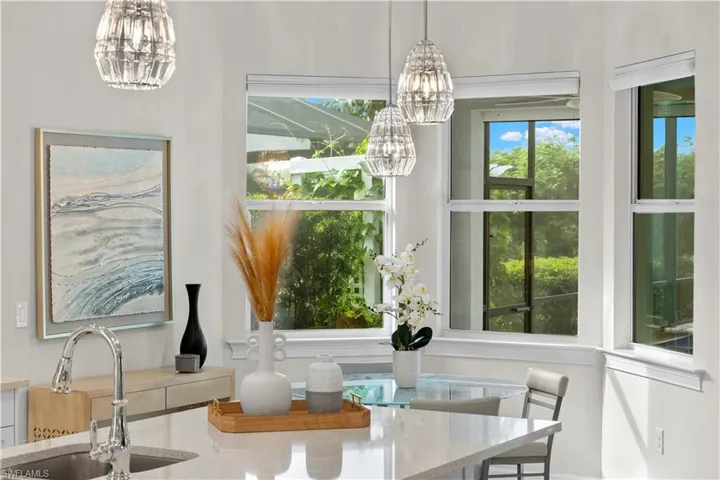 Open kitchen featuring a breakfast nook, and motorized shades
