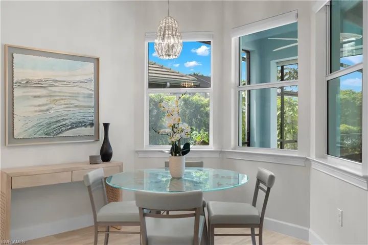 Dining space featuring a chandelier and motorized blinds