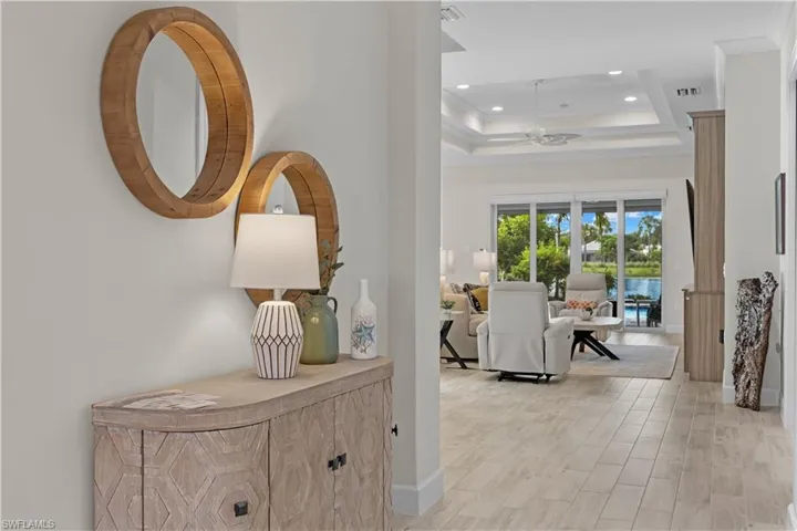 Welcoming foyer featuring a 15'-20' ceilings and light wood-type flooring