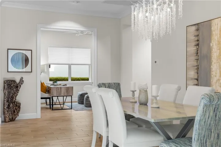 Dining room with crown molding, and a Swarovski chandelier