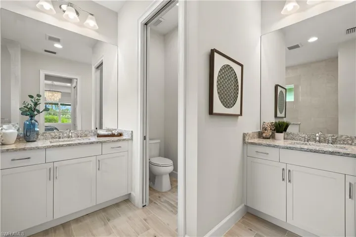 Bathroom with two vanities and toilet