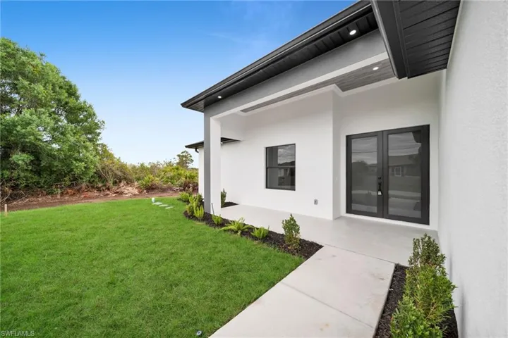 View of yard featuring french doors