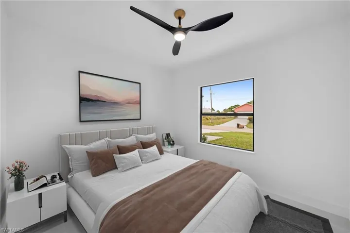 Bedroom with ceiling fan and baseboards