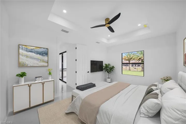 Bedroom with visible vents, a tray ceiling, a ceiling fan, and recessed lighting
