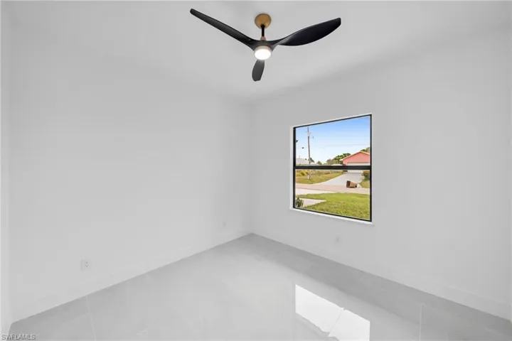 Empty room with a ceiling fan and baseboards