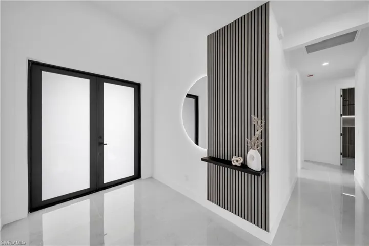Hall with baseboards, marble finish floor, french doors, and recessed lighting
