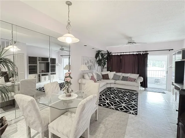 Dining area with ceiling fan and a textured ceiling
