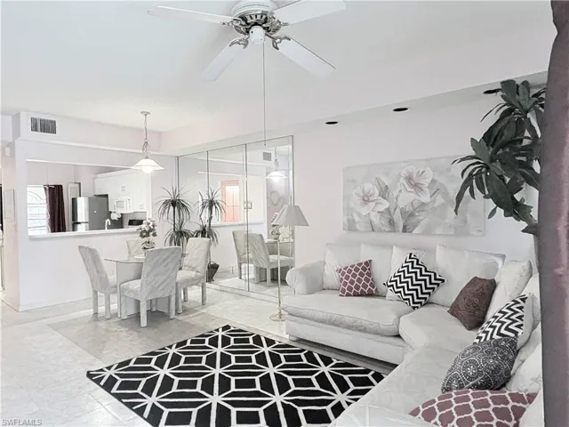 Living room with healthy amount of natural light and ceiling fan