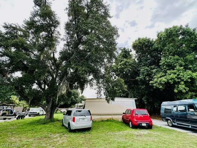 View of vehicle parking featuring a yard