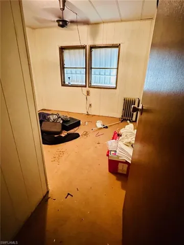 Empty room featuring concrete floors and radiator