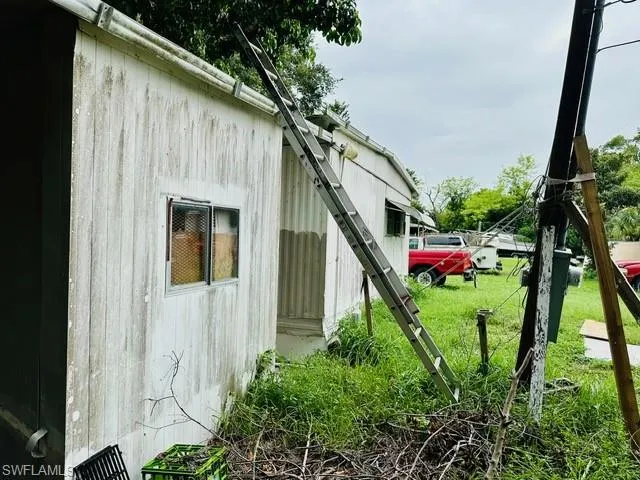 View of side of home featuring a lawn