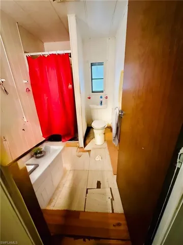 Virtually Staged: Bathroom with toilet and tile patterned floors
