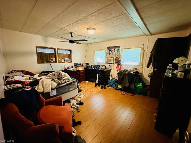 Bedroom with hardwood / wood-style flooring and ceiling fan