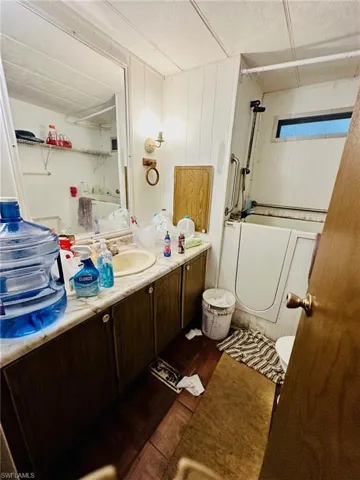 Full bathroom featuring vanity, bathtub / shower combination, wood-type flooring, and toilet