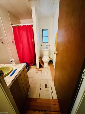 Bathroom featuring tile patterned floors, toilet, and vanity