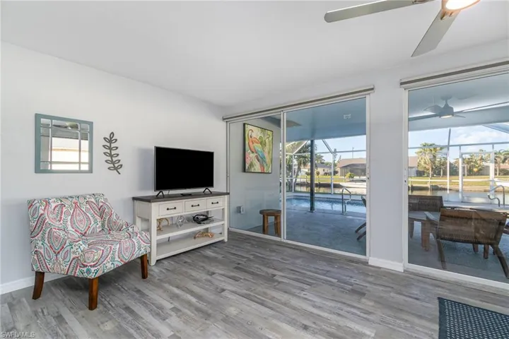 Sitting room with hardwood / wood-style flooring and ceiling fan