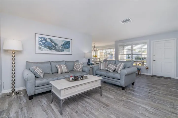 Living room featuring hardwood / wood-style floors and a notable chandelier