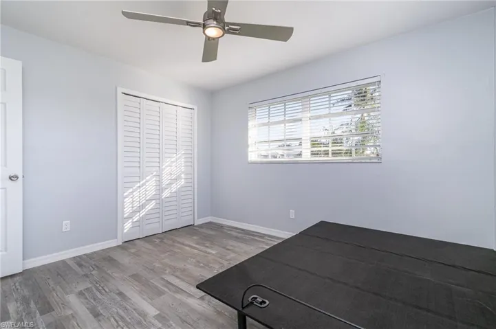 Unfurnished bedroom with ceiling fan, a closet, and light wood-type flooring